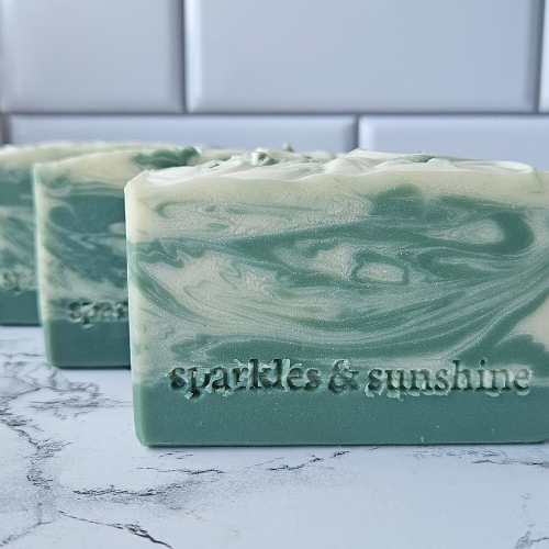 Picture of forest green soap with creamy swirls.