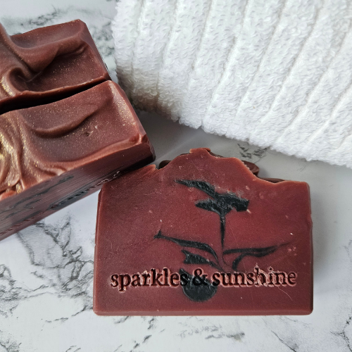 Picture of dark burgundy soap with black feather swirl