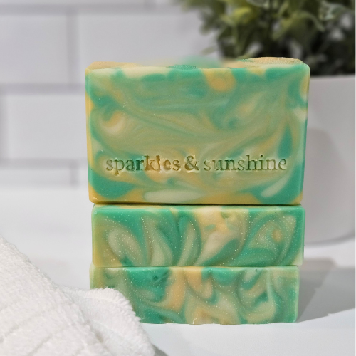 Picture of three bars of soap with green, light orange, and white swirls