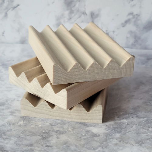 Photo of three stacked wooden soap dishes