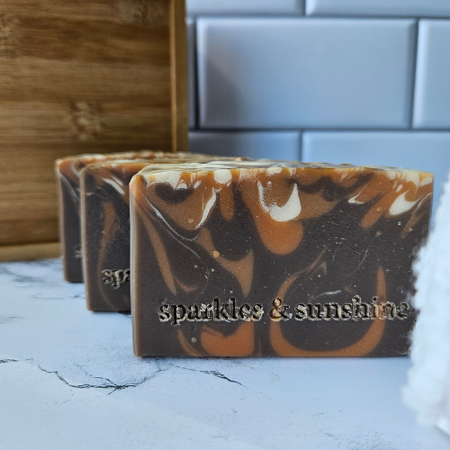 Picture of bar of brown soap with orange and white swirls